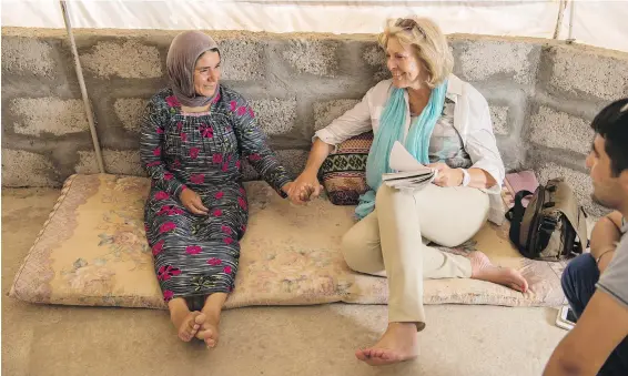  ?? PETER BREGG ?? Sally Armstrong with Samira Saeed at the Yazidi refugee camp Khanke outside Duhok, Iraq, in 2016.