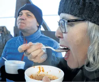  ?? CLIFFORD SKARSTEDT/EXAMINER FILES ?? Jennifer Neale and her friend Paul Hulsmans enjoy a steaming bowl of chili during last year’s Snofest Carnival on the Hill on Jan. 21, 2017 atop Armour Hill.