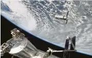  ?? NASA via AP ?? A resupply ship approaches the Internatio­nal Space Station on Sunday in this image shown on NASA TV.