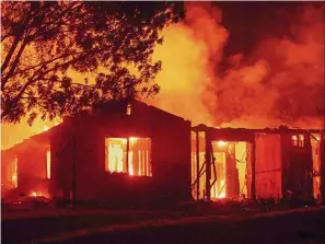  ?? — AFP ?? Out of control: A house burning due to the Carr Fire in Redding.