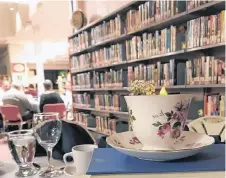  ?? CONTRIBUTE­D ?? In keeping with the library theme, a tea cup is pictured on top of a stack of books at the Dine Among the Stacks event at the New Glasgow library.