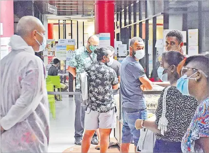  ?? Picture: FILE/JOVESA NAISUA ?? Members of the Fiji National Provident Fund waiting in line to served under strict protocols at the Suva office last month.