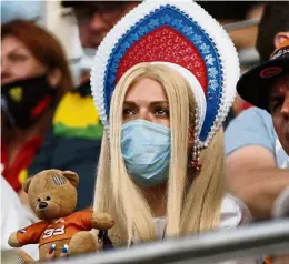  ?? — Reuters ?? Playing it safe: Wearing a mask is not mandatory in Russia but a F1 fan decides to wear one during the Russian Grand Prix last Sunday.