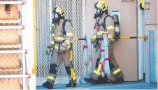  ??  ?? SMOKE DETECTIVES: Firefighte­rs at the CSIRO yesterday.