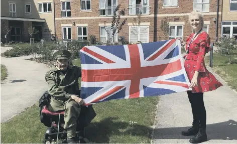  ?? PHOTO SUBMITTED ?? Scarboroug­h resident Alan Hiscox, in uniform, is pictured with Housing Team Leader Amy Veitch in Jazz Court’s garden.