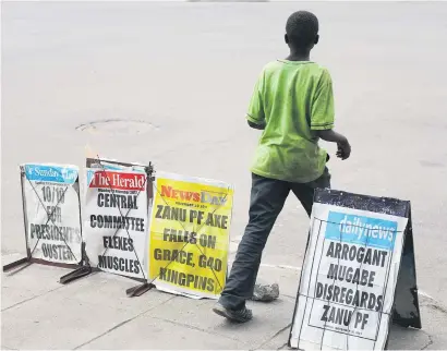  ?? Picture: Reuters ?? SHOUTING OUT. A boy walks past newspaper posters in Harare yesterday.