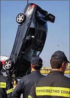  ??  ?? Raised: The car is winched from the sea yesterday