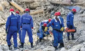  ??  ?? A Russian rescue team clears debris at the explosion site. Photograph: Maxim Grigoryev/