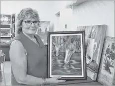  ?? KIRK STARRATT ?? Annapolis Valley Decorative Artists member and art and gift sale chairwoman Brenda Parker with one of her works of art, an acrylic she calls “Mare and Foal.”