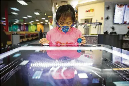  ?? Annie Mulligan / Contributo­r ?? Leelynn Yang, 8, plays a crane game at the Chuck E. Cheese location in Sugar Land last Tuesday.