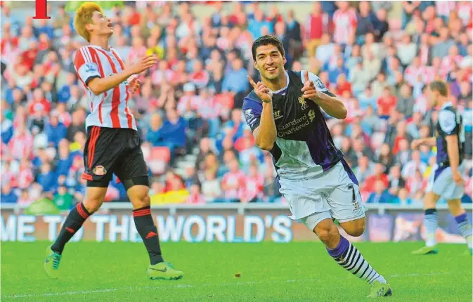  ??  ?? SUNDERLAND: Liverpool’s Uruguayan striker Luis Suarez (right) celebrates scoring his team’s third goal during the English Premier League football match against Sunderland. — AFP