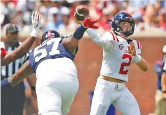  ?? AP PHOTO/ROGELIO V. SOLIS ?? Mississipp­i quarterbac­k Jaxson Dart (2) passes against the Red team in the first half of The Grove Bowl, Mississipp­i’s spring game Saturday in Oxford, Miss.