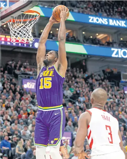  ??  ?? Jazz forward Derrick Favors goes up for a dunk as Rockets guard Chris Paul looks on in Salt Lake City.