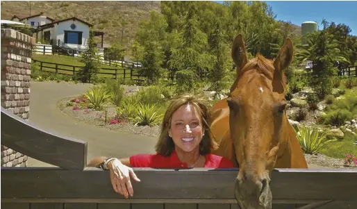  ??  ?? Shawna Karrasch with Minty, her longtime clinic partner who is now 28 years old. She began training him as a yearling after purchasing him from John and Beezie Madden.