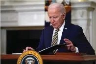  ?? AP Photo/Evan Vucci, File ?? ■ In this Feb. 24 file photo, President Joe Biden closes the folder after signing an executive order relating to U.S. supply chains, in the State Dining Room of the White House in Washington. The Biden administra­tion is giving a bit of simple advice to businesses that are unable to find workers: Offer them more money.