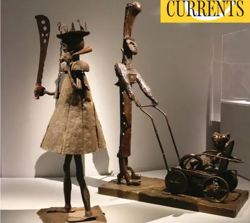  ?? THE WASHINGTON POST ?? The iron warrior made by Dahomey sculptor Akpele Kendo Akati, left, stands next to Pablo Picasso’s Femme à la Poussette in Paris.