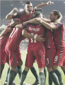  ??  ?? Portugal celebrate Andre Silva’s killer second goal in last night’s 2-0 qualifying win over Switzerlan­d.