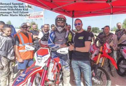  ??  ?? Bernard Sammut receiving the Beta bike from WotoMoto Ktd manager Neil Falzon Photo: Mario Micallef