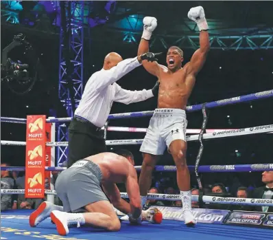  ?? ANDREW COULDRIDGE / REUTERS ?? Anthony Joshua celebrates the first of his three knockdowns against Wladimir Klitschko during their heavyweigh­t title bout at London’s Wembley Stadium on Saturday. Joshua defended his IBF crown and added the WBA and IBO titles to his collection with an...