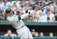  ?? Julio Cortez The Associated Press ?? Aaron Judge follows through on a go-ahead two-run homer in the third inning for the Yankees in their 8-3 win over the Orioles on Saturday at Camden Yards. He went 3-for-5.