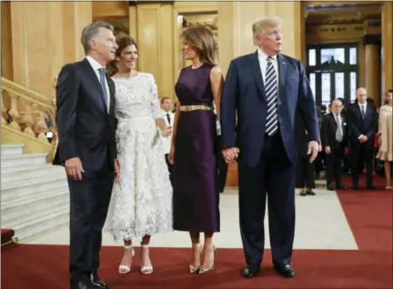  ?? PABLO MARTINEZ MONSIVAIS - THE ASSOCIATED PRESS ?? President Donald Trump and first lady Melania Trump talk with Argentina’s President Mauricio Macri and his wife Juliana Awada as they arrive at the Teatro Colon to join other heads of state for the G20 leaders dinner, Friday in Buenos Aires, Argentina.