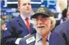  ?? Richard Drew, The Associated Press ?? Trader Peter Tuchman wears a “Dow 23,000” hat as he works Wednesday on the floor of the New York Stock Exchange.