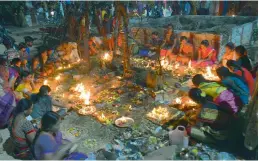  ?? DC ?? Women perform puja by lighting earthen lamps on Kartika Pournami at a temple in Musheeraba­d on Friday. The full moon day in the Hindu month of Kartika is considered to be auspicious day by the devotees of both Lord Shiva and Lord Vishnu. -