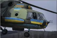  ?? EVGENIY MALOLETKA — THE ASSOCIATED PRESS ?? A Ukrainian pilot waves to his comrades from an Mi-8 combat helicopter during a combat mission in Donetsk region, Ukraine, March 18.