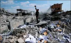  ?? AP PhoTo/hASSAn AMMAr, FIle ?? In this Saturday, April 14 file photo, a Syrian soldier films the damage of the Syrian Scientific Research Center which was attacked by U.S., British and French military strikes to punish President Bashar Assad for suspected chemical attack against...