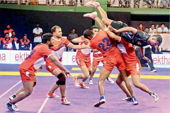  ??  ?? A Warangal Warriors raider leaps over the Ranga Reddy Raiders team during their match in the Telangana Premier Kabaddi League being played at the Jawaharlal Nehru Indoor Stadium at Hanmakonda in Warangal. Ranga Reddy won the match 37-21.