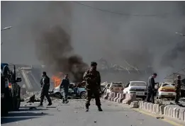  ??  ?? An Afghan security force member stands at the site of a car bomb attack in Kabul on Wednesday. (AFP)