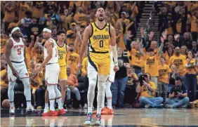  ?? MYKAL MCELDOWNEY/INDYSTAR ?? Indiana Pacers guard Tyrese Haliburton (0) reacts to a made 3-point shot on Friday against the New York Knicks during Game 3 of their Eastern Conference semifinals series.