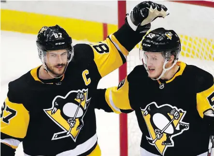  ?? GENE J. PUSKAR/THE ASSOCIATED PRESS ?? Pittsburgh Penguins forward Jake Guentzel, right, celebrates his second goal Thursday night with Sidney Crosby during the Penguins’ 3-1 victory over the Washington Capitals in Game 4 of their second-round series. The goal was Guentzel’s 10th of the...