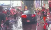  ?? NYPD TWITTER ACCOUNT ?? In this frame grab from a video by @datainput from the New York City Police Department Twitter account, a car moves through protesters, in New York’s Times Square on Thursday.