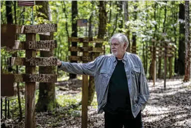  ?? PHOTOS BY ALYSSA POINTER/ALYSSA.POINTER@AJC.COM ?? Bob Hart, an artist who also ran IT for UGA’S college of education, was inspired to create a 9/11 Memorial Trail in a patch of woods in front of his home in Athens, to honor the victims of the attack.