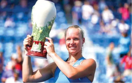  ?? Photo: AP ?? Kiki Bertens lifts the trophy after defeating Simona Halep