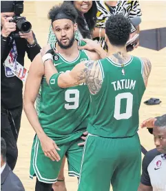  ?? AFP ?? The Celtics’ Derrick White, left, and Jayson Tatum celebrate after defeating the Heat in Game Six of the Eastern Conference finals.