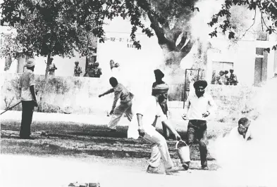  ?? STR / AFP / GETTY IMAGES FILES ?? In this photograph taken on June 7, 1984, an Indian Sikh throws a tear-gas canister back at Indian police after it was
fired to break up violence around the Golden Temple as news of the death of a Sikh leader spread in Amritsar.