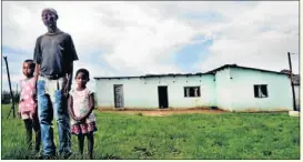  ??  ?? Alloys Msuthu of Ramafole in Eastern Cape standing with his children. He suffers from silicosis, a lung disease affecting miners.