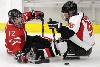  ?? CANADIAN PRESS FILE PHOTO ?? Greg Westlake, pictured left battling against Japan in 2012 in Calgary, has been telling people since ’03 he plays sledge hockey. Now he’s not sure what to say when people ask about his sport.