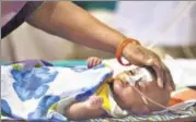  ?? AFP ?? A child at the encephalit­is ward of the BRD hospital being looked after by his mother in Gorakhpur on Monday.