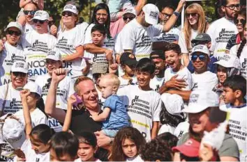  ?? Antonin Kélian Kallouche/Gulf News ?? ■ Families, both with and without children with Down syndrome, participat­ed in a Fun Walk at Dubai Creek yesterday.