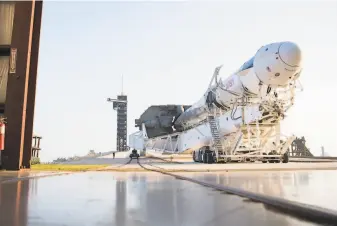  ?? NASA ?? A SpaceX Falcon rocket with the company’s Dragon spacecraft rolls out of a facility at Kennedy Space Center in Cape Canaveral. Liftoff for the Internatio­nal Space Station is set for Thursday.