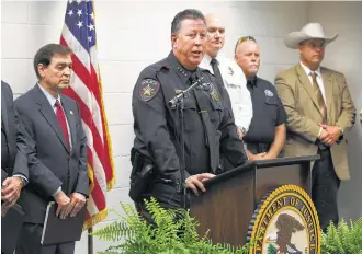  ?? Bob Owen / San Antonio Express-News ?? “It has taken an awful lot to get here today,” said Victoria Police Chief Jeffrey Craig, center, following the announceme­nt of an indictment in the burning of the Victoria Islamic Center.