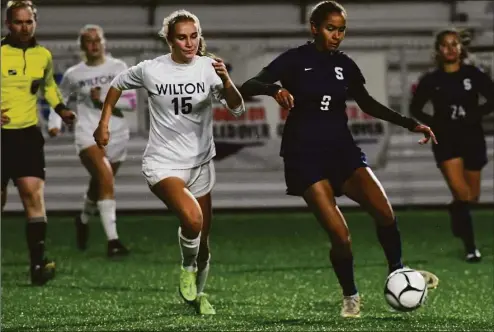  ?? Erik Trautmann / Hearst Connecticu­t Media ?? Staples and Wilton played to a tie in the 2021 CIAC Class LL girls soccer championsh­ip. Teams will determine a champion with penalty kicks this year.