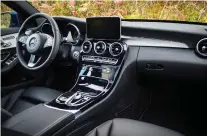  ?? NICK TRaGIANIS/DRIVING ?? A look at the inside the 2018 Mercedes-Benz C300, above, and the Genesis G70.