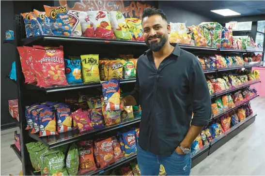  ?? TERRENCE ANTONIO JAMES/CHICAGO TRIBUNE PHOTOS ?? Zohaib Naman is an owner of Exotic Snack Guys, a shop on Lincoln Avenue in Chicago that sells snacks from around the world and does mail-order business in addition to its retail outlet.