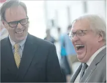  ?? PIERRE OBENDRAUF ?? Peter Kruyt, left, the new chairman of the board at the MUHC, shares a laugh with Health Minister Gaétan Barrette during the introducti­on of the hospital’s new board on Monday.