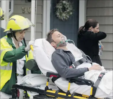  ?? Peter J. Casey, Reuters ?? A victim is taken away by paramedics after a U.S. navy F/A-18D fighter jet crashed into an apartment complex in Virginia Beach, Va., on Friday. The navy fighter crashed soon after takeoff, injuring seven people and damaging several buildings.