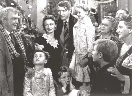  ?? RKO PICTURES ?? James Stewart as George Bailey, center, is reunited with his wife, played by Donna Reed, third from left, and family during the last scene of Frank Capra’s “It’s a Wonderful Life.”